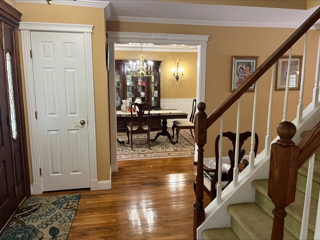 36VANDERBILT 36 Vanderbilt Ave, Saint James, NY 11780 - entrance foyer featuring stairs, wood-type flooring, ornamental molding, and a chandelier