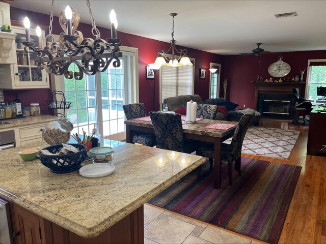 36VANDERBILT 36 Vanderbilt Ave, Saint James, NY 11780 - dining room featuring a chandelier, a ceiling fan, and a glass covered fireplace