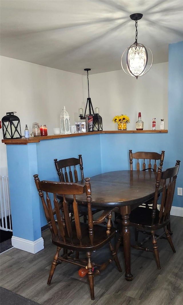 dining room featuring baseboards and wood finished floors