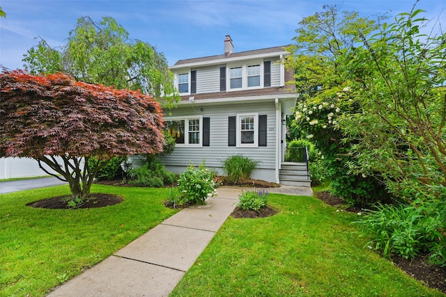 224 Leicester St, Port Chester, NY 10573 - view of front of house featuring a chimney and a front lawn