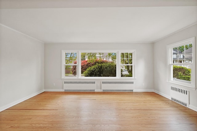 224 Leicester St, Port Chester, NY 10573 - spare room featuring radiator heating unit, light wood-style floors, and crown molding