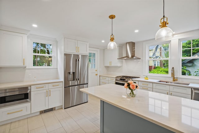 224 Leicester St, Port Chester, NY 10573 - kitchen with appliances with stainless steel finishes, wall chimney exhaust hood, a sink, healthy amount of natural light, and recessed lighting
