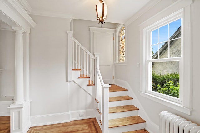 224 Leicester St, Port Chester, NY 10573 - stairs featuring radiator heating unit, healthy amount of natural light, crown molding, and ornate columns