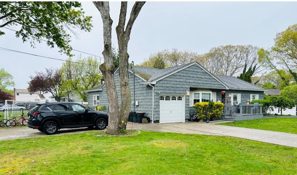 single story home with an attached garage, driveway, and a front lawn