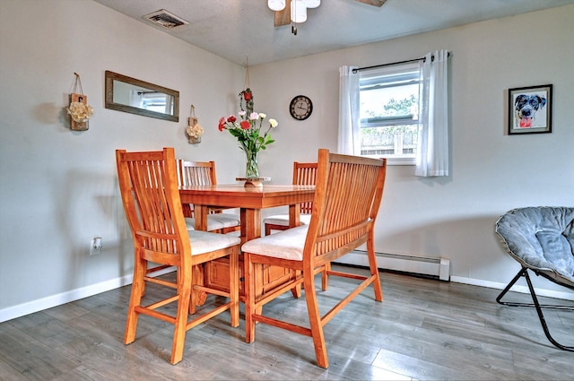 80 Saint Anns Ave, Copiague, NY 11726 - dining area with a baseboard heating unit, a ceiling fan, wood finished floors, and baseboards