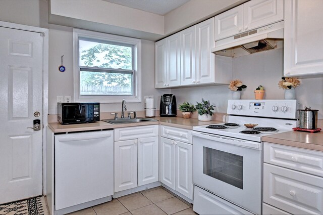 80 Saint Anns Ave, Copiague, NY 11726 - kitchen featuring white appliances, under cabinet range hood, a sink, light countertops, and white cabinets