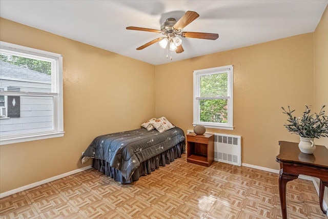 39-27 216th St, Bayside, NY 11361 - bedroom with radiator heating unit, baseboards, and ceiling fan