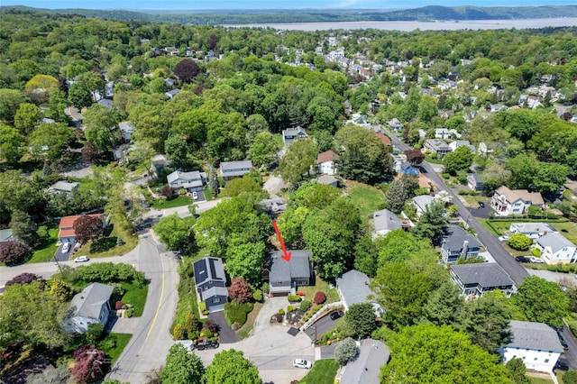 aerial view of property and surrounding area with nearby suburban area and a large body of water
