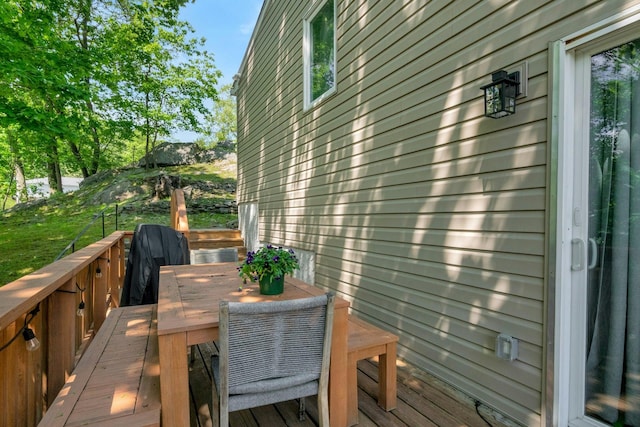 wooden terrace with outdoor dining area