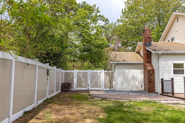 view of yard featuring a gate and a fenced backyard
