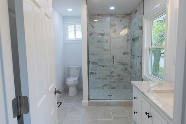 bathroom featuring a stall shower, recessed lighting, baseboards, toilet, and vanity