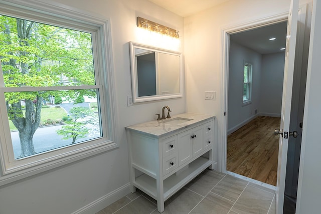 bathroom with vanity and baseboards