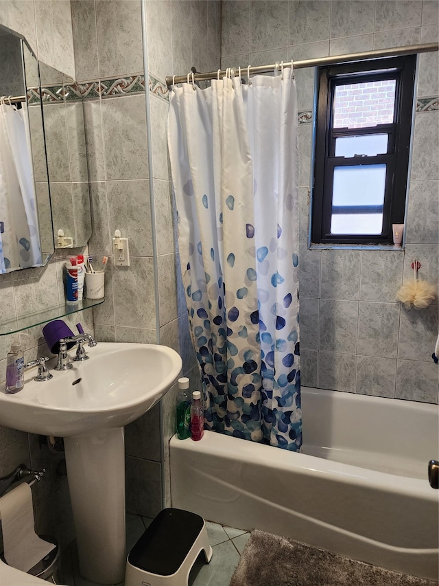 bathroom featuring tile patterned floors, tile walls, and shower / bath combination with curtain