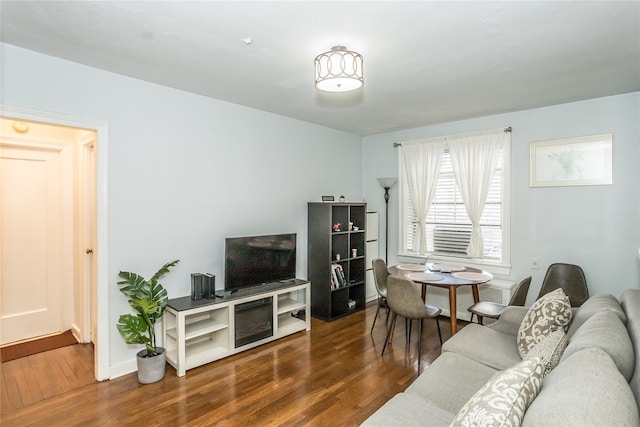 living room featuring baseboards and wood finished floors