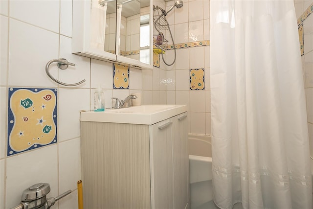 full bath featuring shower / tub combo with curtain, vanity, tile walls, and tasteful backsplash