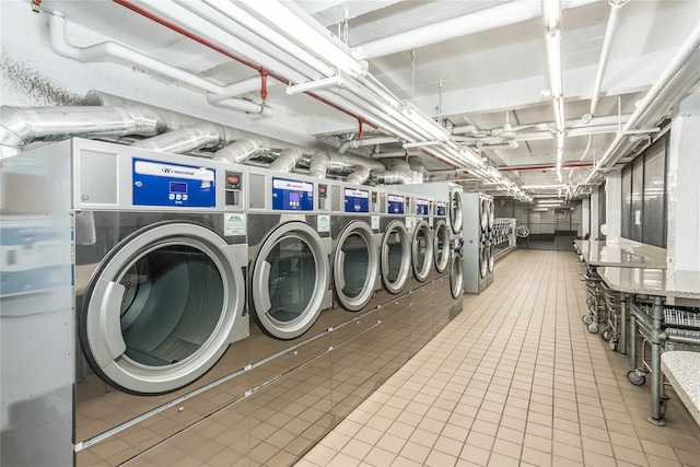 common laundry area featuring washing machine and dryer and tile patterned flooring