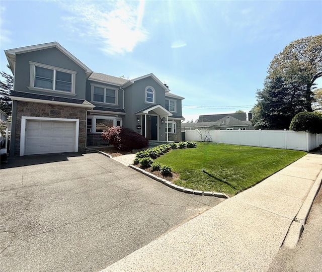 1601 Union Ave, Hewlett, NY 11557 - view of front of house featuring fence, an attached garage, stucco siding, a front yard, and aphalt driveway