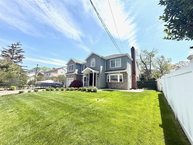 1601 Union Ave, Hewlett, NY 11557 - view of front of property featuring stone siding, a chimney, fence, and a front yard