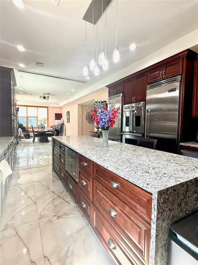 1601 Union Ave, Hewlett, NY 11557 - kitchen with built in appliances, marble finish floor, decorative light fixtures, light stone counters, and visible vents
