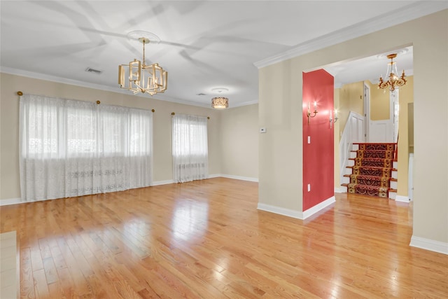 unfurnished living room featuring light wood-style flooring, baseboards, stairs, a chandelier, and crown molding