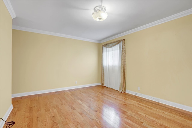 unfurnished room with light wood finished floors, baseboards, and ornamental molding