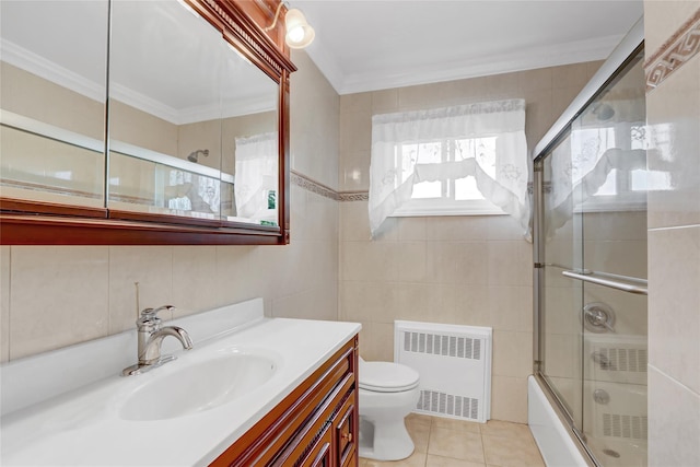 full bathroom featuring toilet, ornamental molding, radiator heating unit, shower / bath combination with glass door, and tile patterned flooring