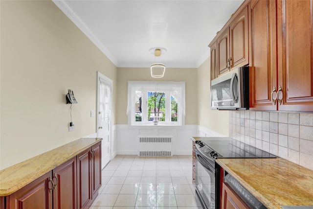 kitchen featuring radiator, black / electric stove, stainless steel microwave, crown molding, and tasteful backsplash