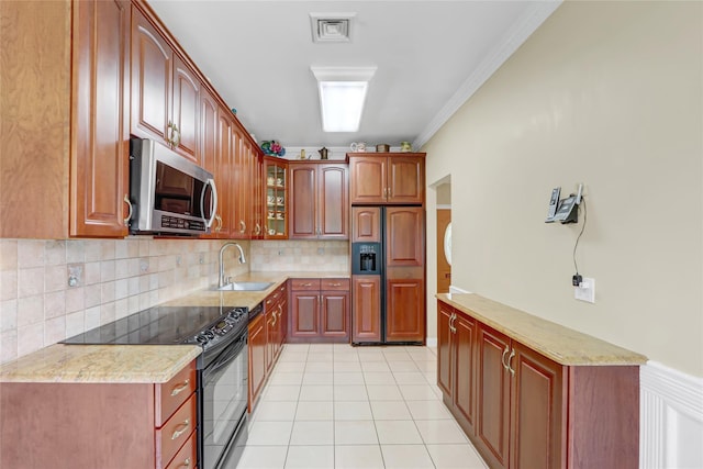 kitchen with stainless steel microwave, a sink, paneled built in refrigerator, black / electric stove, and glass insert cabinets
