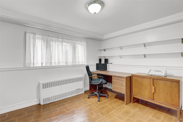 office with ornamental molding, radiator, baseboards, and light wood-type flooring