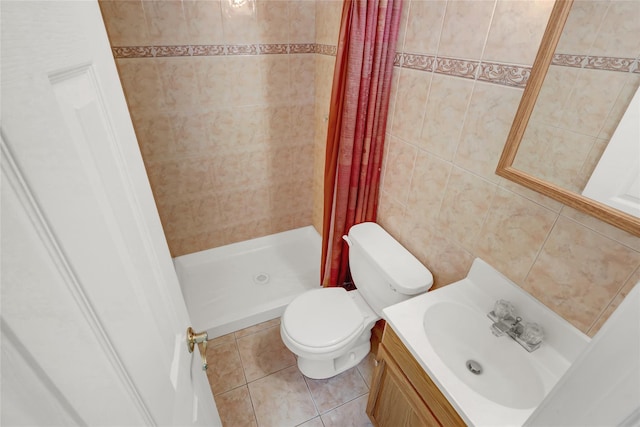 bathroom with tile patterned floors, vanity, toilet, and a stall shower