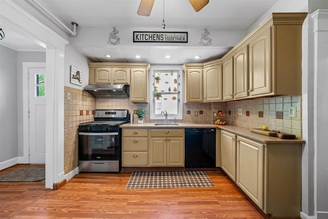 kitchen with under cabinet range hood, stainless steel range with gas stovetop, a sink, light wood-style flooring, and dishwasher