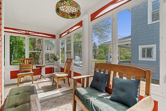 sunroom featuring ornamental molding