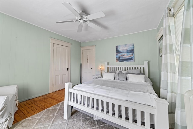 bedroom featuring a ceiling fan and wood finished floors