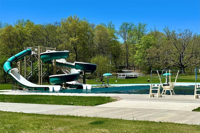 view of property's community with a yard and playground community
