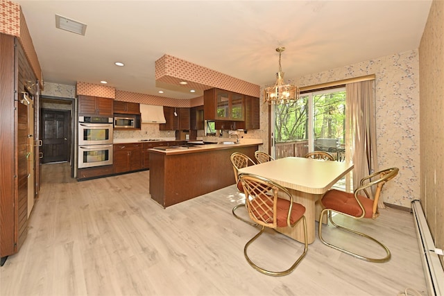 11 Sterling Rd, Spring Valley, NY 10977 - dining space with baseboard heating, wallpapered walls, light wood-style flooring, a chandelier, and recessed lighting