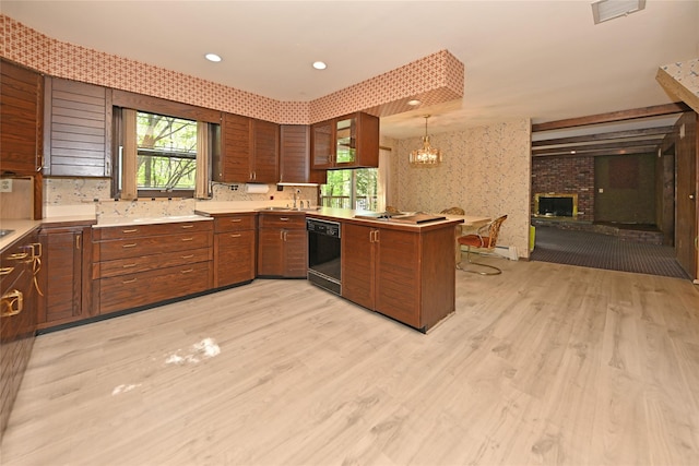 11 Sterling Rd, Spring Valley, NY 10977 - kitchen with dishwasher, a sink, a peninsula, light wood-type flooring, and light countertops