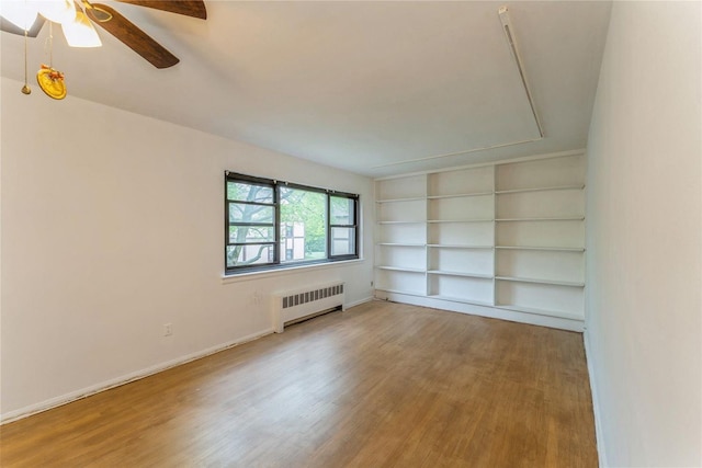 274 Cherry Valley Ave Unit B-2, Garden City, NY 11530 - unfurnished room featuring radiator heating unit, wood finished floors, a ceiling fan, built in features, and baseboards