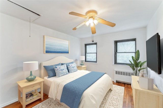 274 Cherry Valley Ave Unit B-2, Garden City, NY 11530 - bedroom featuring radiator heating unit, attic access, wood finished floors, and ceiling fan