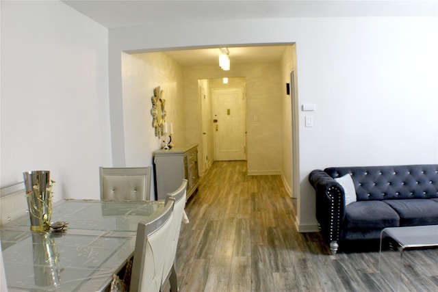 hallway featuring baseboards and wood finished floors