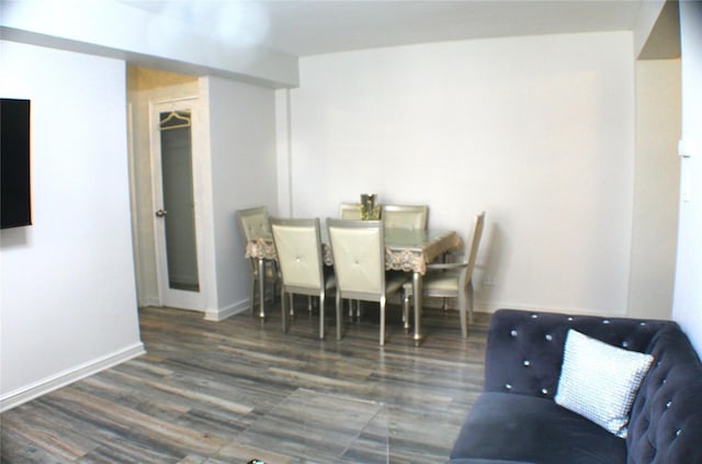 dining area featuring baseboards and wood finished floors