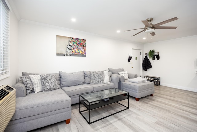 living room featuring light wood-type flooring, a ceiling fan, crown molding, baseboards, and recessed lighting
