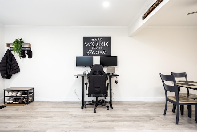 office space with wood finished floors, ornamental molding, and baseboards