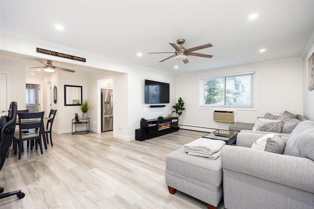 living room with a ceiling fan, light wood-style flooring, recessed lighting, a baseboard heating unit, and baseboards