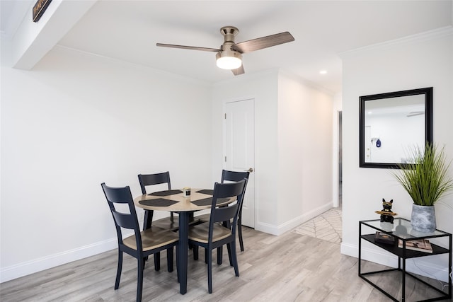 dining space featuring light wood-type flooring, crown molding, baseboards, a ceiling fan, and recessed lighting