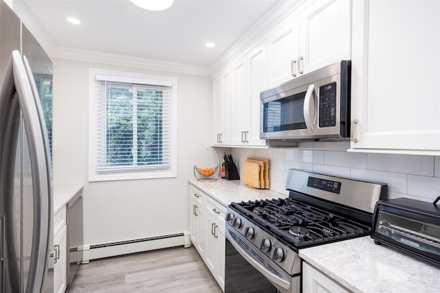 kitchen featuring appliances with stainless steel finishes, a baseboard radiator, crown molding, white cabinets, and tasteful backsplash