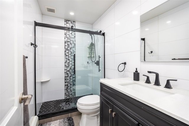 full bath featuring a shower stall, toilet, and vanity