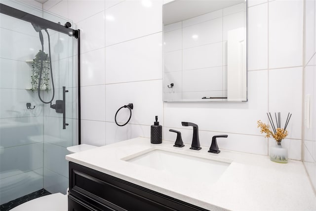 full bath with a shower stall, vanity, and toilet