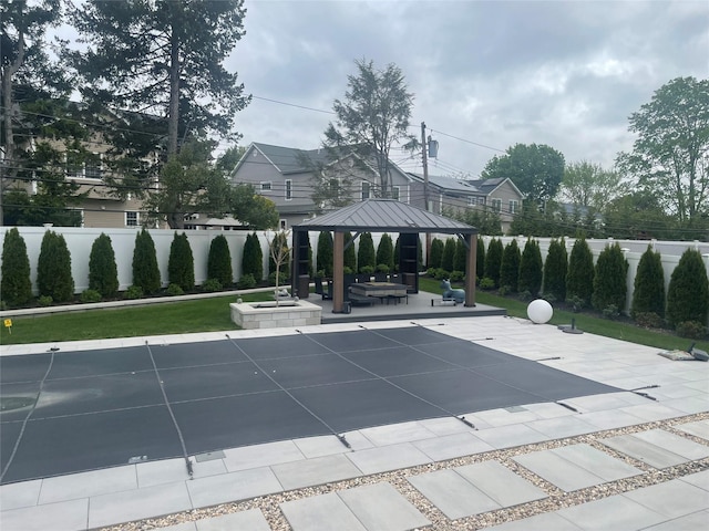 view of swimming pool with a gazebo, fence, a patio, and a pool