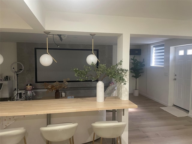 bar with baseboards and wood finished floors