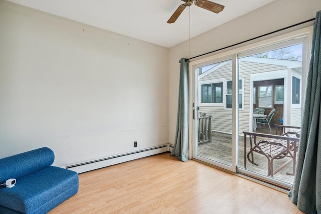 16 Edwards Ln E, Blue Point, NY 11715 - living area with a baseboard radiator, wood finished floors, and a ceiling fan